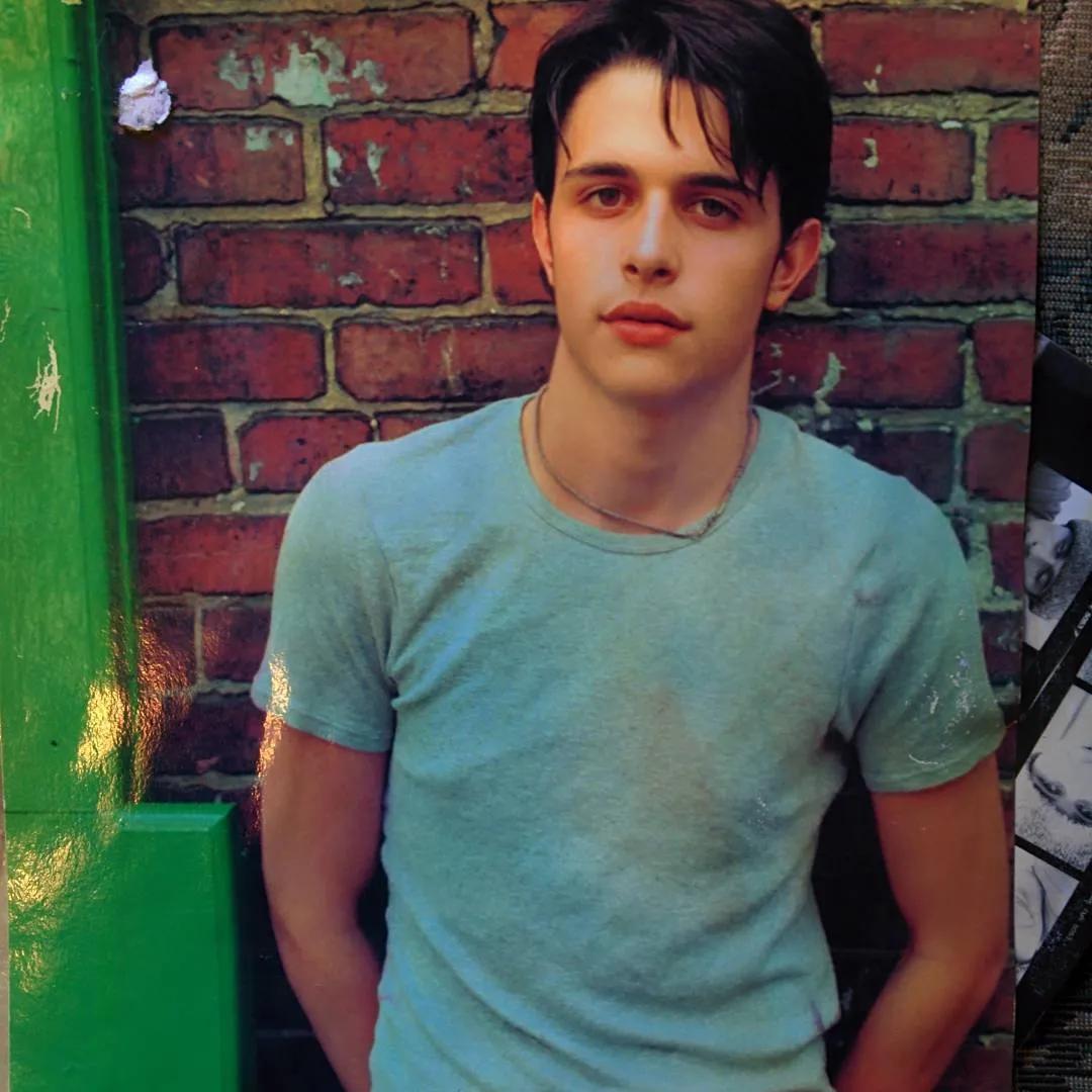 Modeling shot of Jake in a t-shirt against a brick wall